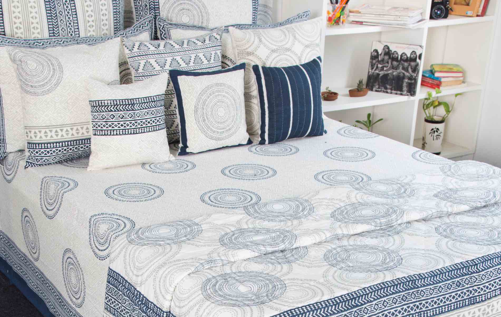 Hand-block printed bed cover and cushions in indigo and ivory